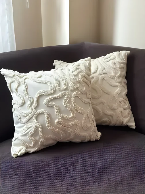Embroidered cushions on a sofa